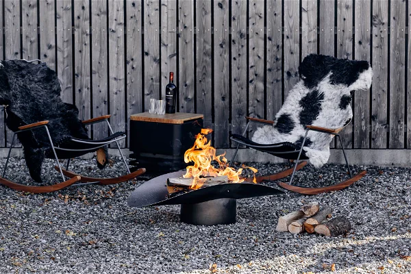 An image of a fire pit set up in the backyard in black and white theme