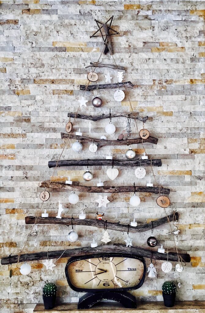 A modern Christmas tree idea with wooden sticks and a Christmas ball
