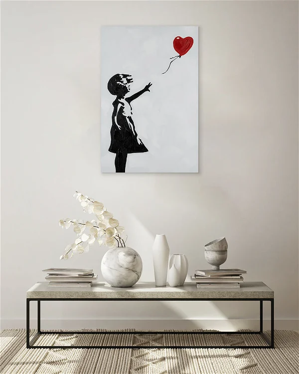 A living room with a acrylic painting of a girl reaching a red balloon