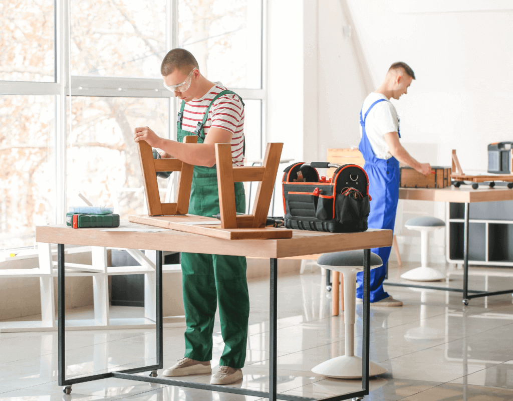 Two man working in a well lit working area customizing a chair for the living room