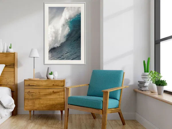 A living room with a poster of ocean in green white color.
