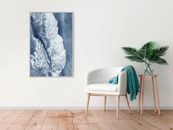 A cozy corner with a portrait of a ocean in blue color.