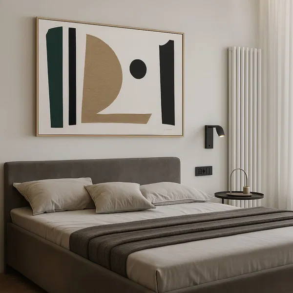 A bedroom with pillows and bedding, featuring a minimalist artwork in green, black, and gold tones placed above the bed.