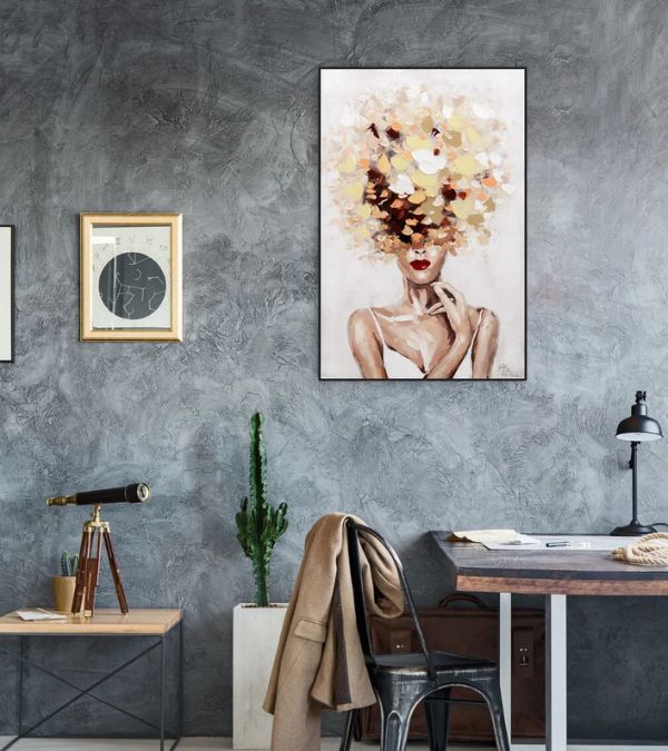 A textured gray wall setting featuring a vertical portrait painting titled "Autumn's Muse" showing a woman with a voluminous, golden-toned abstract floral hairstyle.